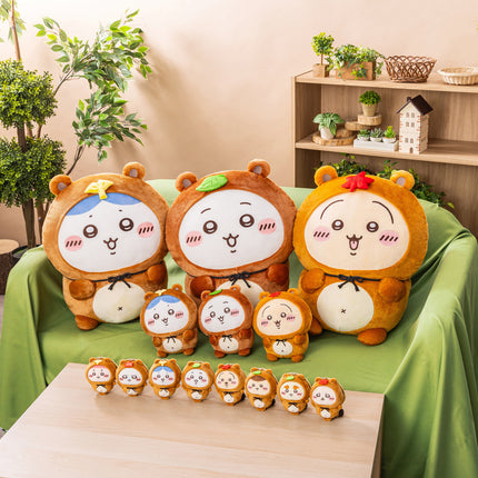 Set of small tanuki-themed plush toys and keychain, grouped on a table