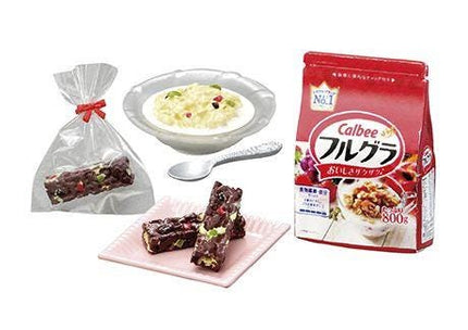 various food items, including a bowl of soup, a bag of Calbee's cereal, a plate of chocolate bars, and a spoon.