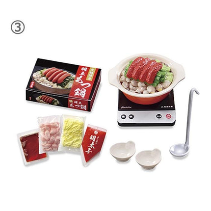 various food items and kitchen utensils, including a box of food, a bowl of food, a spoon, and some small bowls.