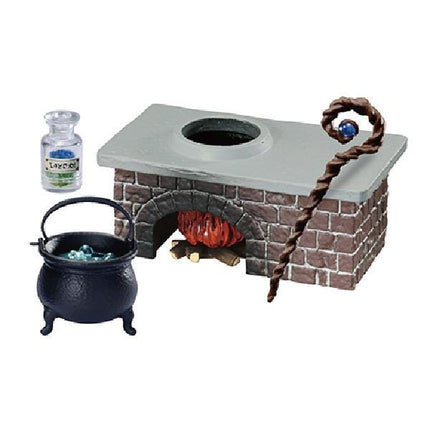 A miniature set depicting a small brick oven with a pot on top, a cauldron, and a staff with a blue ball on it.