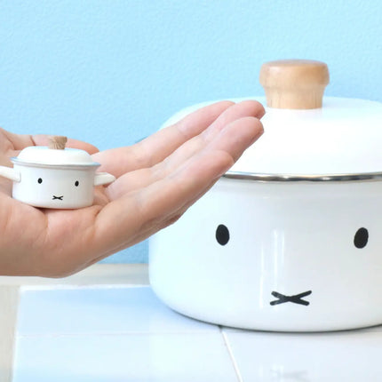 White miniature Miffy teapot with lid and wood knob, held in a hand, face print