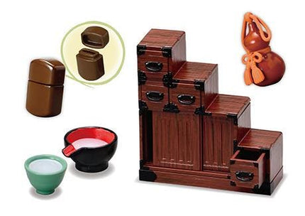 various small wooden objects, including a wooden cabinet, a wooden bowl, and a wooden box. There is also a small wooden box with a handle and a small wooden box with a handle.