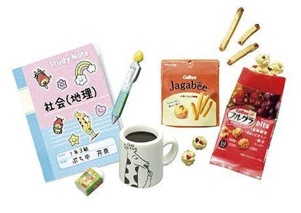 various items, including a pink book with Japanese text, a pencil, a coffee cup, a bag of cookies, and a small bag of chips.
