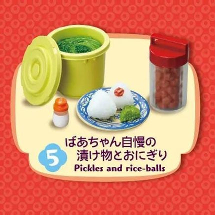 various food items, including a green container, a plate with pickles and rice balls, and a red container. The image also includes text that reads "Pickles and rice-balls" and "5".