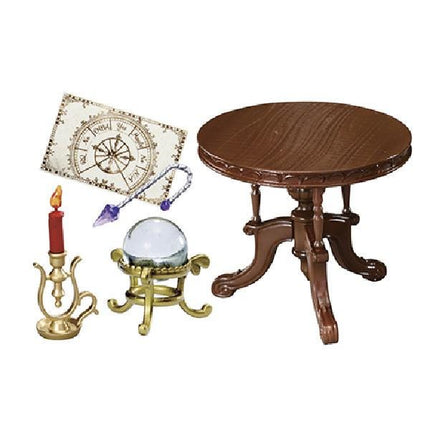 a wooden table, a candle, a crystal ball, and a map, all arranged together.