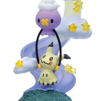 A figurine of a character from the Pokémon franchise, specifically Pikachu, is displayed on a base with clouds and stars in the background.