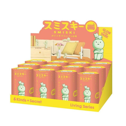 A display of Smiski figurines, a living series of small, anthropomorphic animals, in a pink and yellow box.