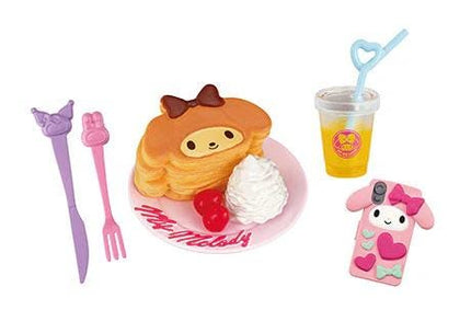 a variety of colorful and whimsical items, including a stack of pancakes with a bow, a pink cup with a straw, a pink phone, a purple fork, and a pink and white doll.