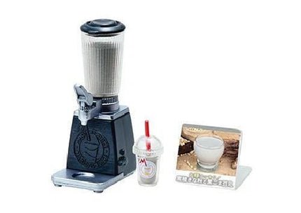 A black and silver blender, a clear plastic cup with a red straw, and a picture of a milkshake on a stand.