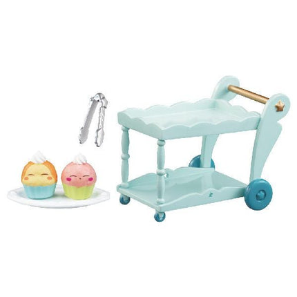 A light blue toy kitchen cart with two cupcake-shaped figures on a white plate, along with a pair of tongs.