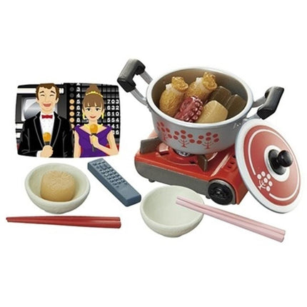 a toy kitchen set with a man and a woman, a toy stove, and various cooking utensils such as a bowl, spoon, and chopsticks.
