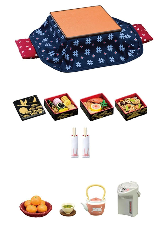 various food items and kitchen utensils, including a wooden tray, four small boxes, a bowl of oranges, a teapot, a kettle, and a white container.
