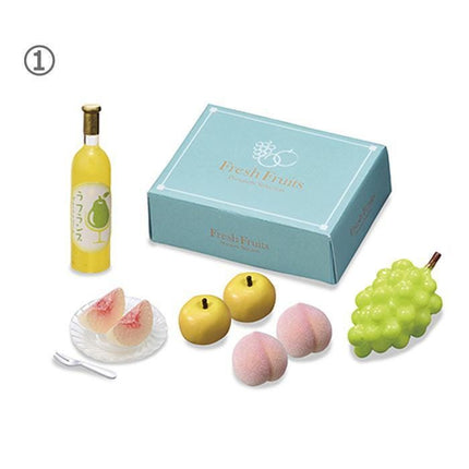 a variety of fruits and a bottle of juice, arranged on a white background.