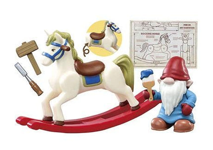 A toy gnome is sitting on a rocking horse, holding a paintbrush, and there is a drawing of a gnome and a rocking horse in the background.