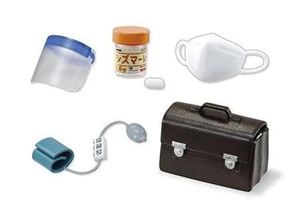 various medical and personal care items, including a face shield, a pill bottle, a mask, a blood pressure monitor, and a briefcase.