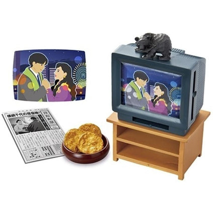 a television, a newspaper, and a bowl of cookies.