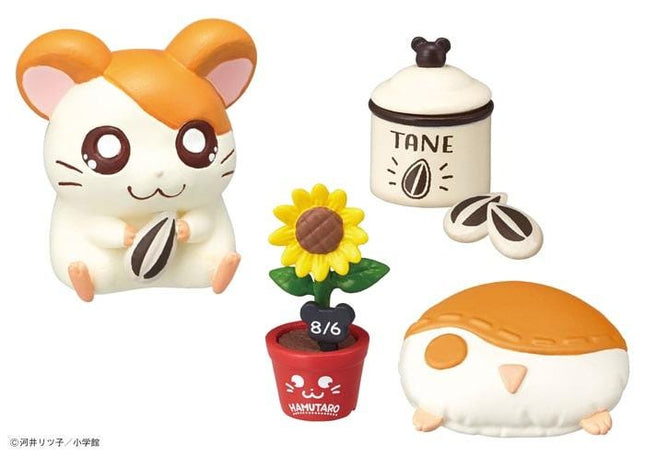 a variety of colorful and whimsical toys, including a hamster figurine, a sunflower, a potted plant, a small red pot, and a stuffed animal.