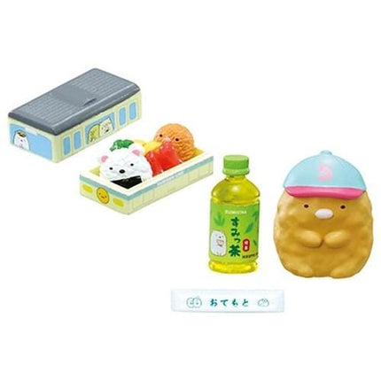 various colorful toys and objects, including a toy box, a toy cap, a bottle, and a small toy animal.