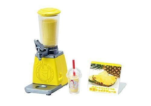 A yellow blender with a clear plastic cup and a picture of a pineapple on a sign are shown in the image.
