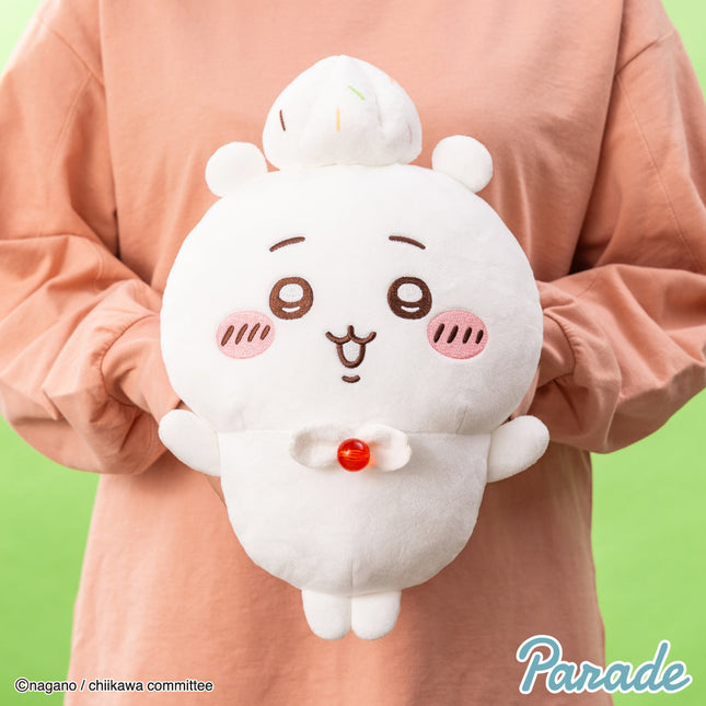 White round big plush toy with cat face, small paws, and a red nose button.