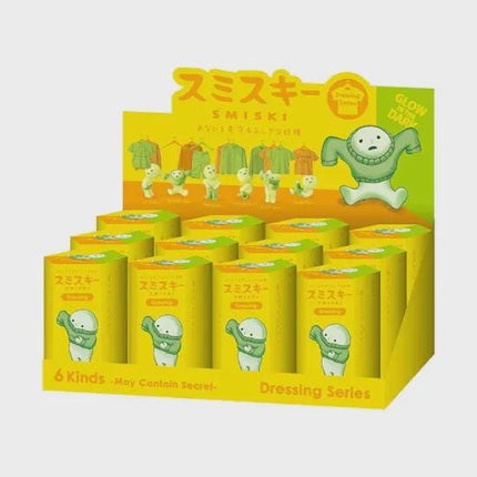 A display case containing a set of yellow boxes with images of cartoon characters, likely representing a dressing series.