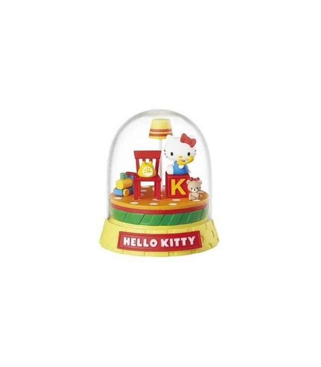 A Hello Kitty snow globe with a lamp, chair, and other decorative elements.
