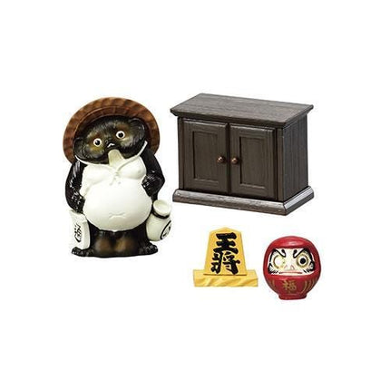 a figurine of a bear, a wooden cabinet, and two small dolls, all arranged together.