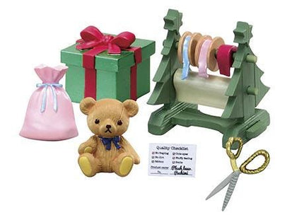 a teddy bear, a gift box, a pair of scissors, and a tag with a list of items.