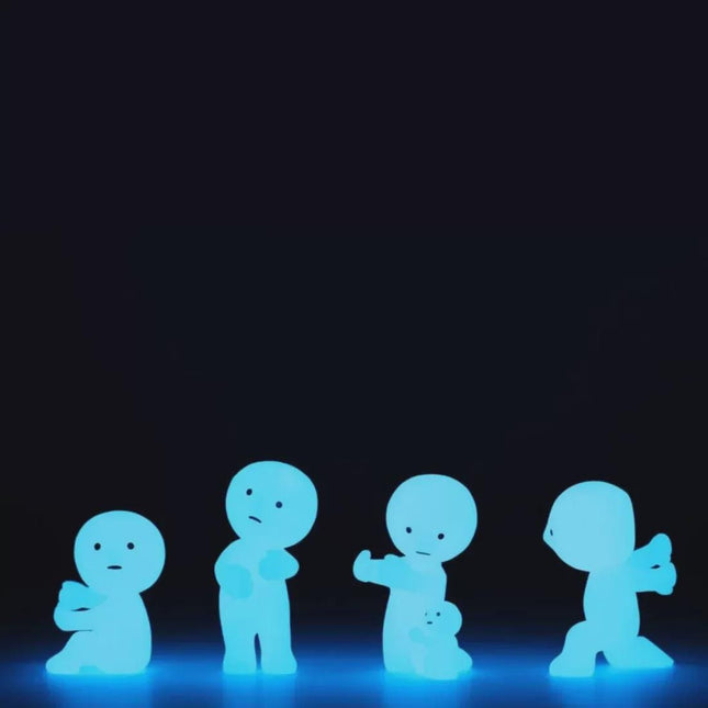 four small, glowing figurines arranged in a row against a dark background.