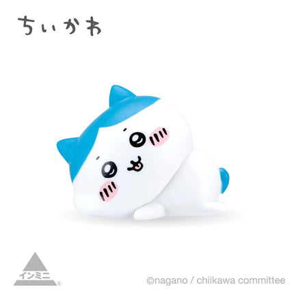 Interior mini figure, white seal-like character with blue fin, curled