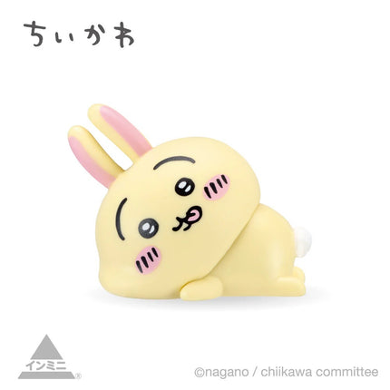 Interior mini figure, yellow bunny-like character with long pink ears, curled