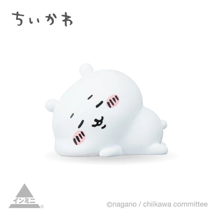 Interior mini figure, white seal-like character with closed eyes, curled