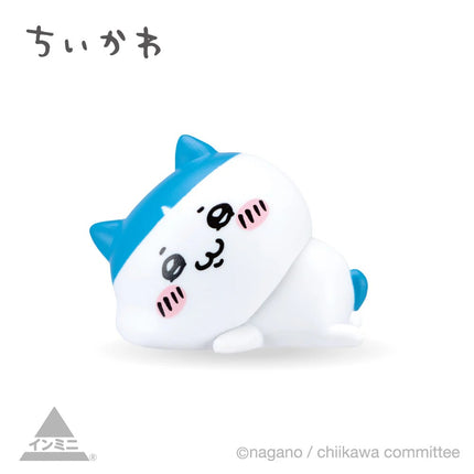Interior mini figure, white seal-like character with blue fin, resting pose