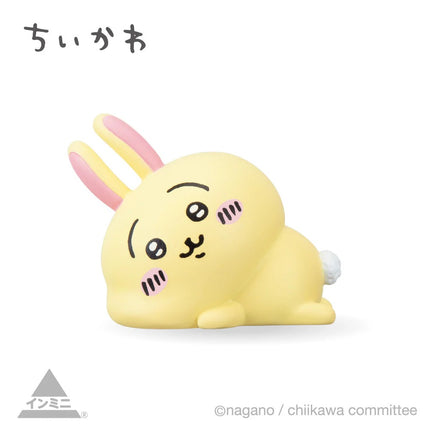 Interior mini figure, yellow bunny-like character with pink ears, curled