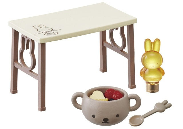 Dollhouse tea set with small table, golden rabbit figure, cup, and spoon accessory