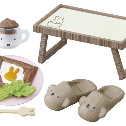Dollhouse meal set with table, tea cup, plate with bread, and sleeping mouse pieces