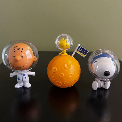 Set of 3 astronaut capsule toys with clear helmets, orange ball base, and trophy figure