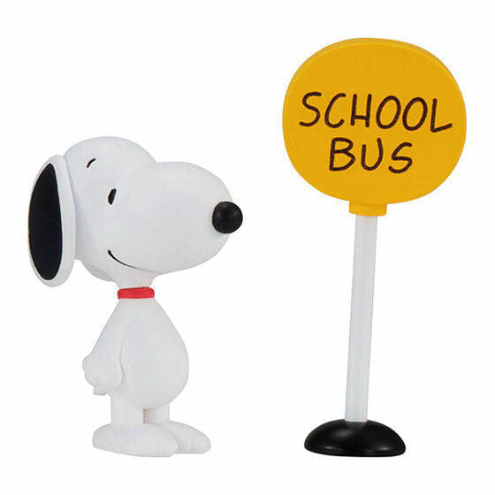 Snoopy capsule toy figure with a yellow sign on a white post