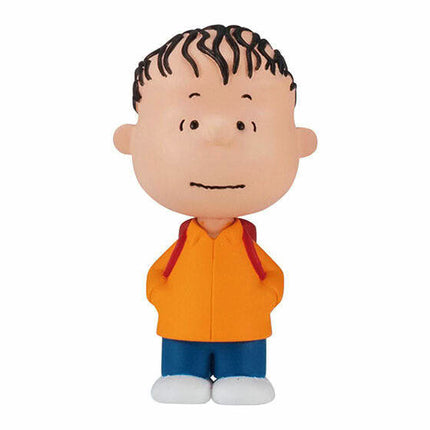 PEANUTS capsule toy figure of a boy in an orange shirt and blue shorts