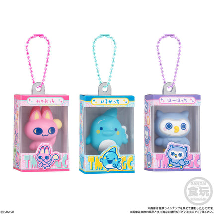 Three boxed gumiture charms with pink, blue, and purple beaded keychains