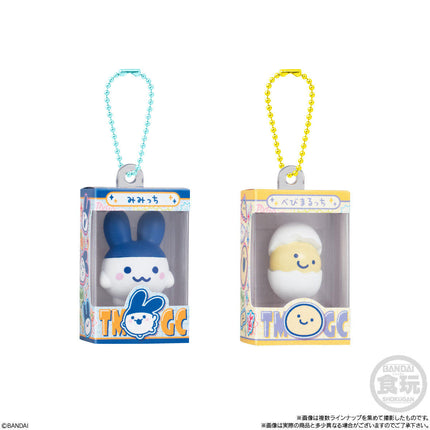 Two boxed gumiture charms: blue figure and white-yellow figure with bead keychains