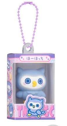 Bandai Tamagotchi gumiture charm with white cat character in boxed package and purple bead necklace