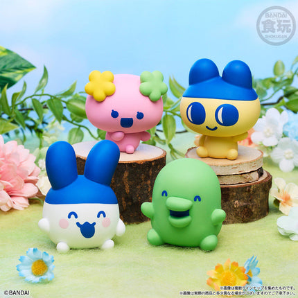 Group of soft vinyl character figures on cut tree stumps in bright garden colors
