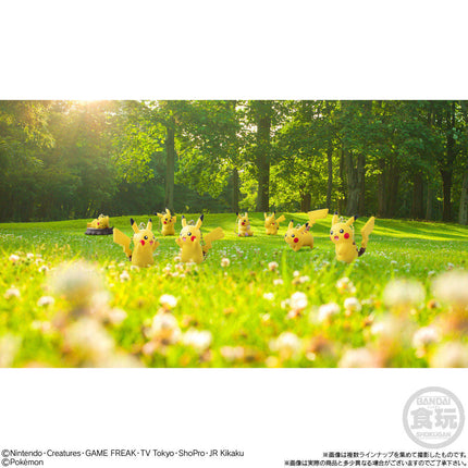 Set of Pikachu mascot keychains in a grassy outdoor scene, small yellow figures