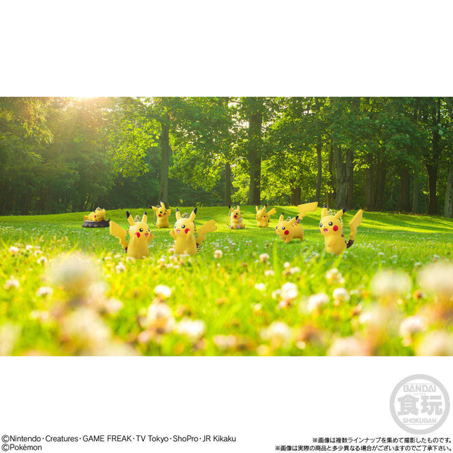 Set of Pikachu mascot keychains in a grassy outdoor scene, small yellow figures