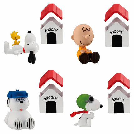 Four Snoopy vignette figures with red-roof houses arranged in a grid