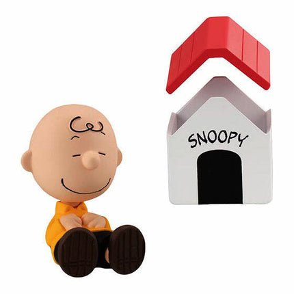Charlie Brown figurine with white house accessory labeled “SNOOPY”