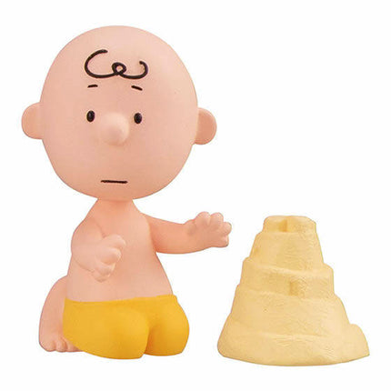 Peanuts-style figure with bald head, yellow shorts, and a yellow cone accessory