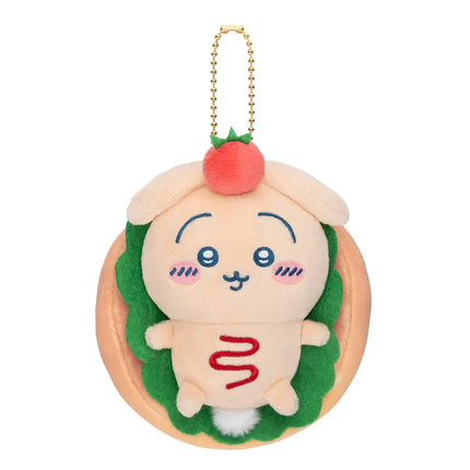 Plush bakery sandwich mascot keychain with green body, pale face, red pom-pom and gold chain