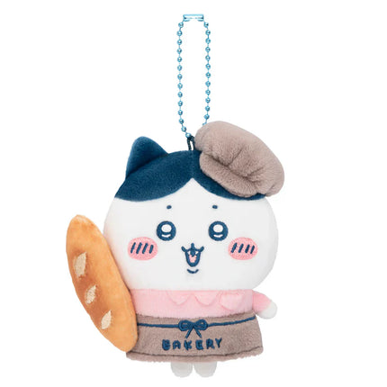 Blue bakery staff mascot plush with brown chef hat and blue beaded necklace